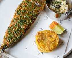 Alma Cocina Latina signature dishes Arepas with fillings like shredded beef or chicken avocado, Pabellón Criollo, Ceviche, Whole Fried Fish.